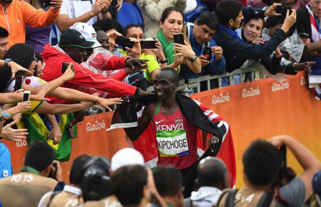 Eliud Kipchoge celebrates his Olympic marathon win in Rio.(Photo by Norman Katende)