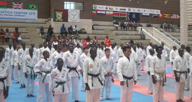 Participants gather and await instructions during the opening ceremony of the Mombasa Tong-Il-Moo-Do championship at the Aga Khan Academy in Mombasa on Saturday.